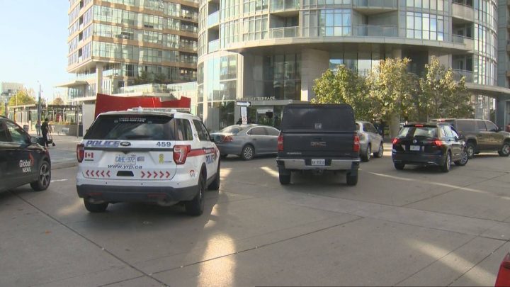 Police cars outside a building in Fort York that was raided Thursday.