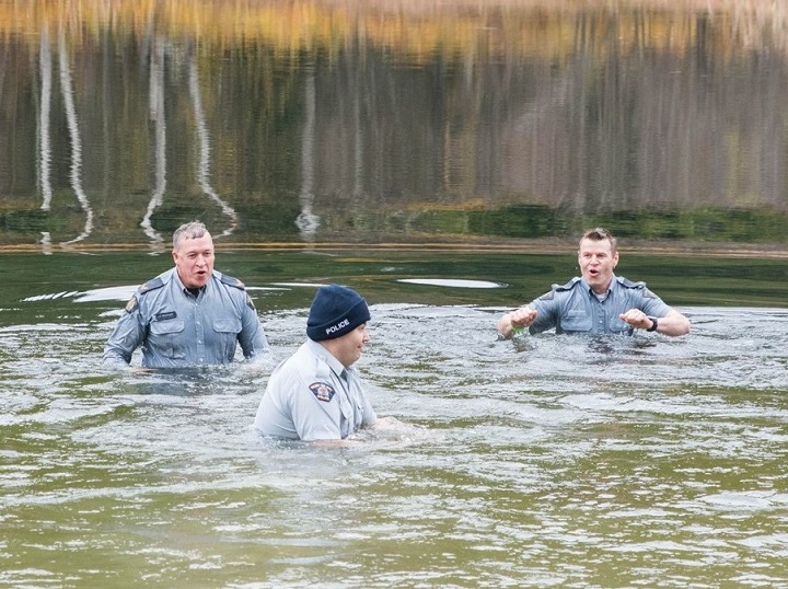 Revelstoke RCMP detachment members Cpl. Thomas Blakney, left, Const. Josh McCann and Cpl. Mike Esson plunged into the frigid waters of Williamson Lake on Sunday to raise money for Special Olympics B.C.