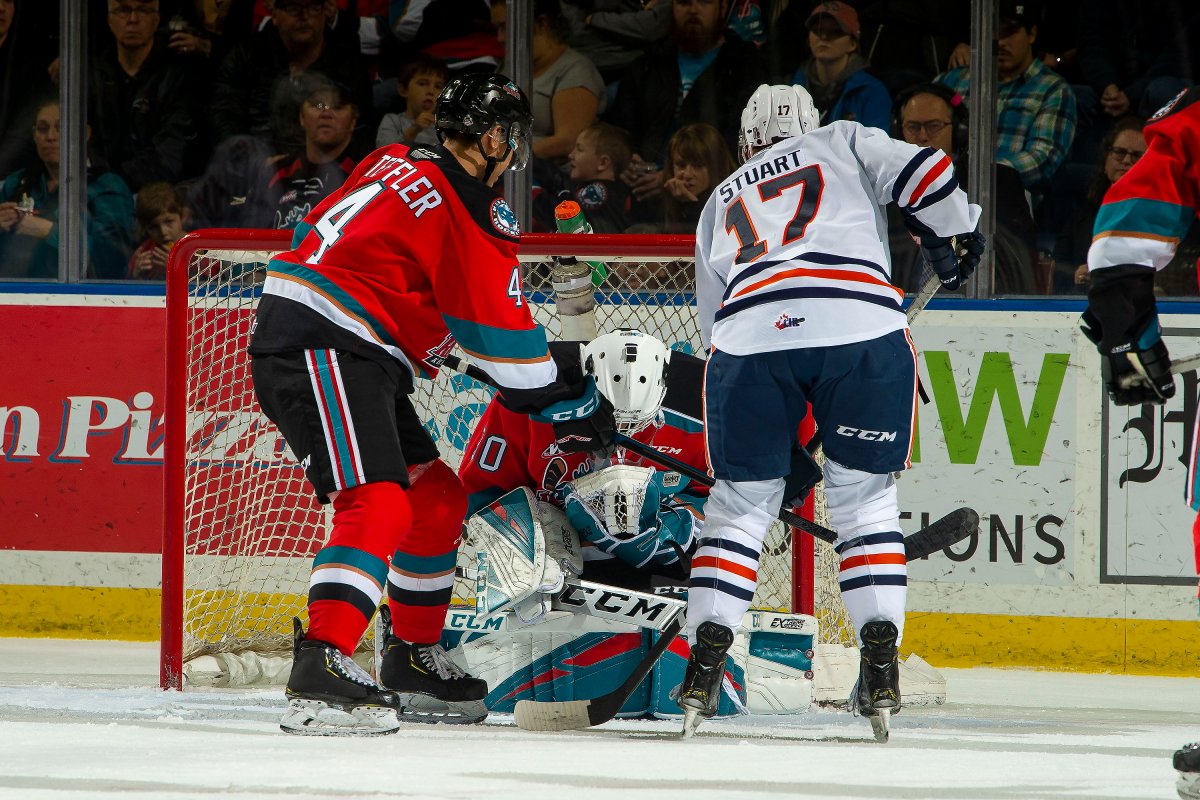 During last week's match-up with the Blazers, Roman Basran makes a save as Devin Steffler of the Kelowna Rockets stick checks Brodi Stuart of the Kamloops Blazers at Prospera Place on October 12, 2019. 