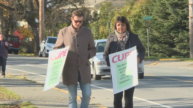 Saanich support workers picket outside one of the district's 18 schools.