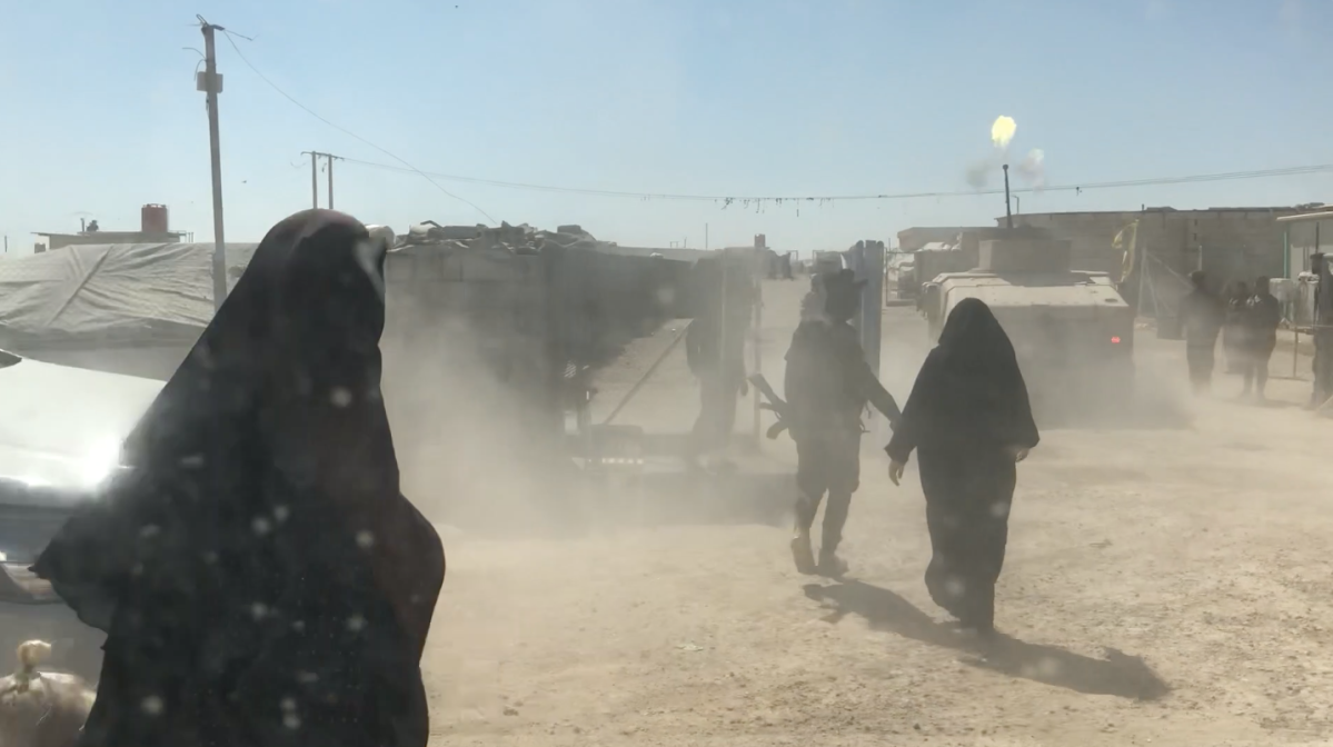 An armed vehicle fires as it enters Al-Hawl camp in northern Syria during a disturbance by ISIS detainees.
