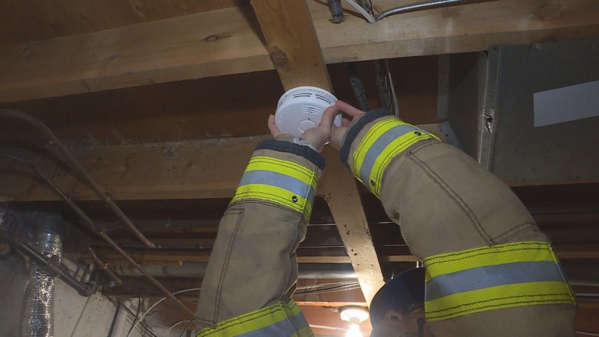 Calgary firefighters install a free smoke detector as part of Fire Prevention Week.