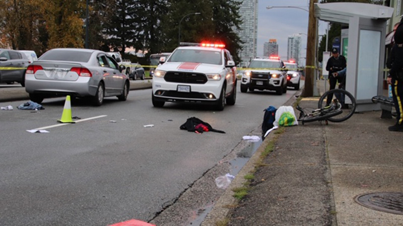 Police and paramedics at the scene of a collision involving a vehicle and a cyclist who was critically injured on Oct. 18, 2019.