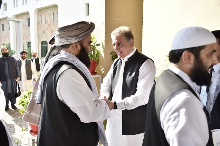 In this photo released by the Foreign Office, Pakistan's Foreign Minister Shah Mehmood Qureshi, center, receives members of Taliban delegation at the Foreign Office in Islamabad, Pakistan, Thursday, Oct. 3, 2019. 