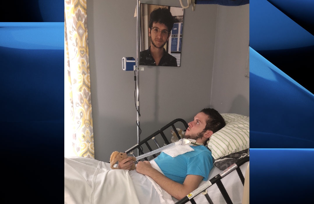 Tristan Roby rests in the living room of his mother’s home following a months-long stay at a London hospital.