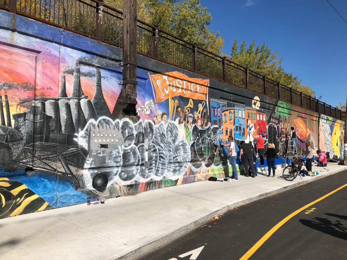 The Pointe-Saint-Charles community came together to re-paint a defaced mural, Oct 12, 2019.