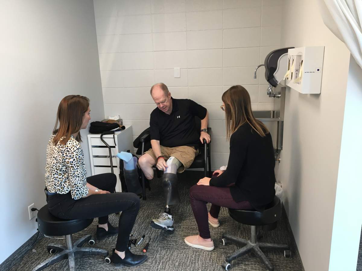 Stene with team at Colman Prosthetics.