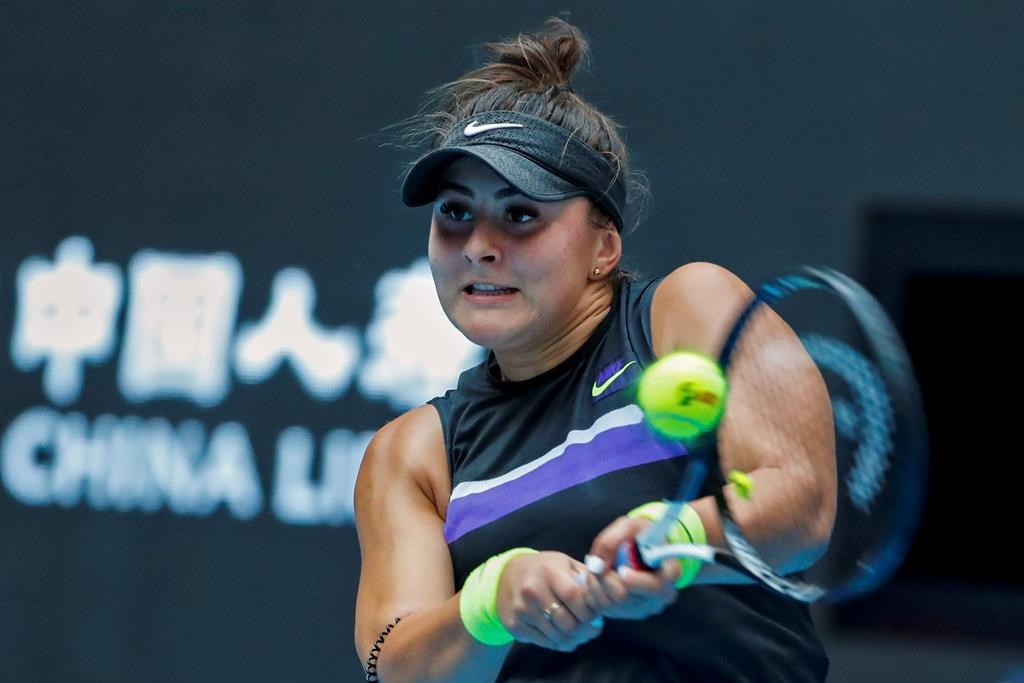 Bianca Andreescu of Canada hits a return shot against Elise Mertens of Belgium during their second round of the women's singles match in the China Open tennis tournament at the Diamond Court in Beijing, Wednesday, Oct. 2, 2019.