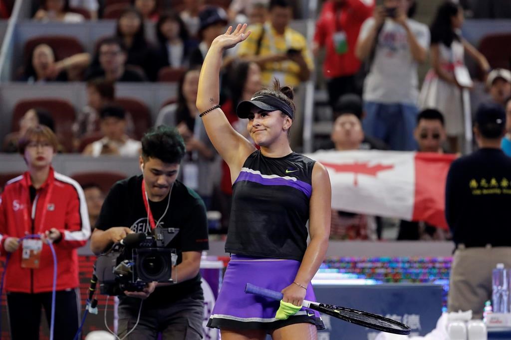 Bianca Andreescu of Canada waves to spectators after defeating Jennifer Brady of the United States in their third round of the women's singles match in the China Open tennis tournament at the Diamond Court in Beijing, Thursday, Oct. 3, 2019.