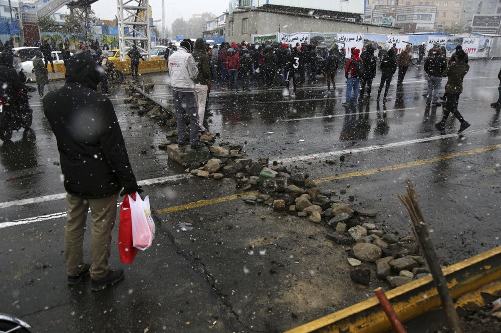 A road is blocked by protestors after authorities raised gasoline prices, in Tehran, Iran, Saturday, Nov. 16, 2019. Protesters angered by Iran raising government-set gasoline prices by 50% blocked traffic in major cities and occasionally clashed with police Saturday after a night of demonstrations punctuated by gunfire. 