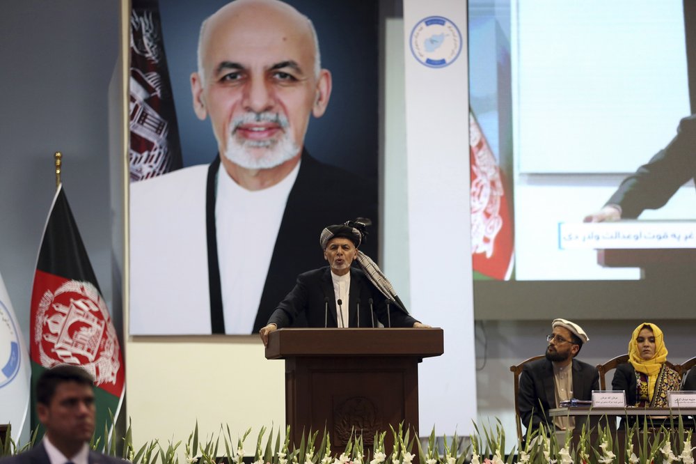 FILE - In this May 3, 2019, photo, Afghan President Ashraf Ghani speaks on the last day of the Afghan Loya Jirga meeting in Kabul, Afghanistan. Taliban officials have told The Associated Press that three Taliban prisoners released by Kabul have been flown to Qatar for a swap for an American and an Australian hostage held by the insurgents. The three Taliban prisoners were to have been freed more than one week ago by Afghan President Ashraf Ghani. 