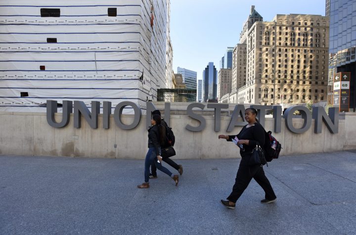 Pedestrians walk past a sign outside Toronto's Union Station.