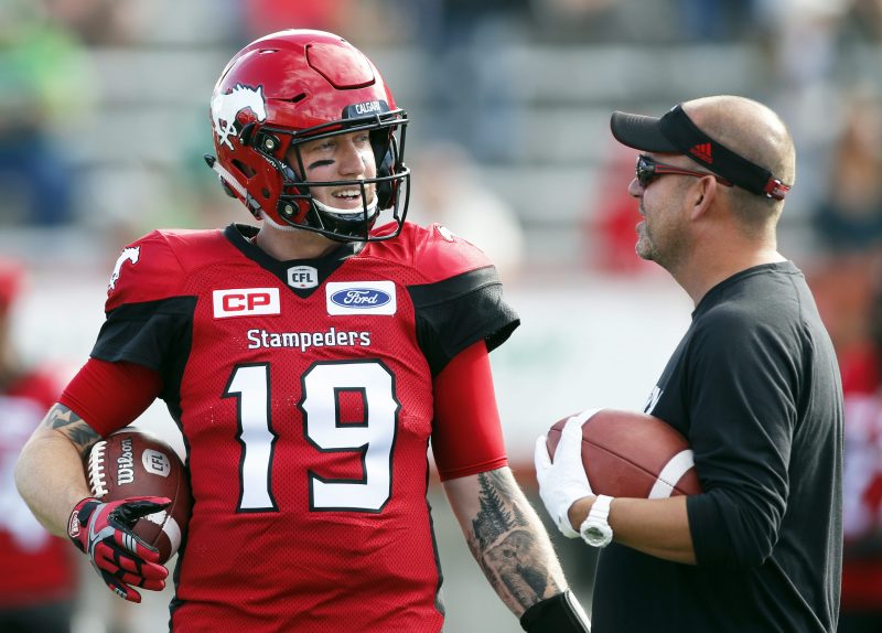 Calgary Stampeders quarterback Bo Levi Mitchell, left, talking to receivers coach Pete Costanza prior to a game in Calgary. on Saturday, July 22, 2017. 