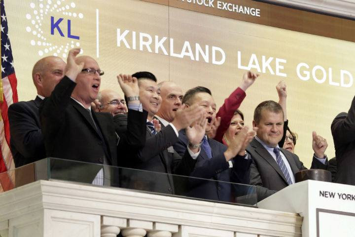 Kirkland Lake Gold President & CEO Anthony Makuch, right, gives a thumbs-up as he rings the New York Stock Exchange opening bell, to mark his company's listing, Wednesday, Aug. 16, 2017. (AP Photo/Richard Drew).