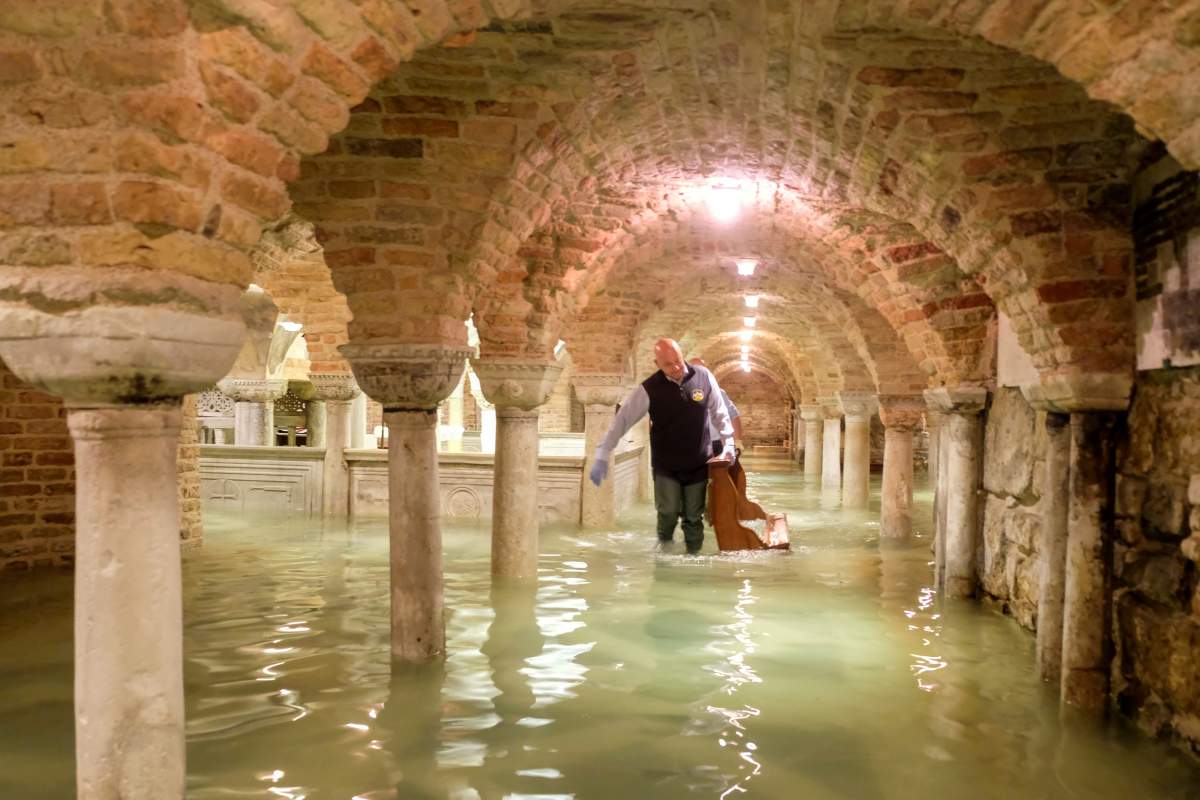 A man wades in the flooded crypt of St Mark’s Basilica during a period of exceptionally high water levels in Venice, Italy on Nov. 13.