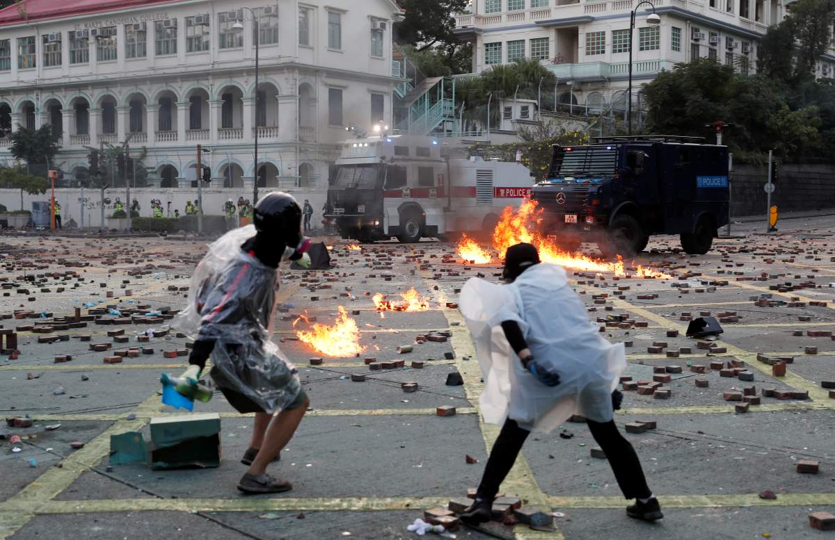 Anti-government protesters throw Molotov cocktails towards police vehicles during clashes, outside Hong Kong Polytechnic University (PolyU) in Hong Kong, China, on Nov. 17, 2019. (REUTERS/Tyrone Siu)