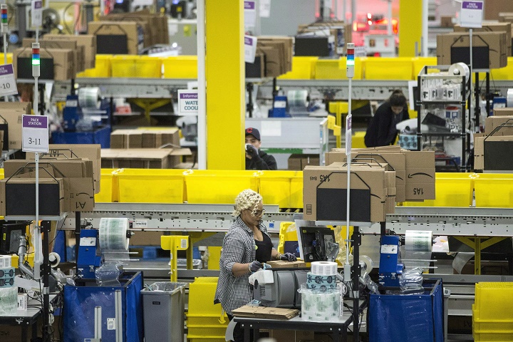 Employees work at the Amazon fulfillment centre in Brampton, Ont., on November 26, 2018. 
