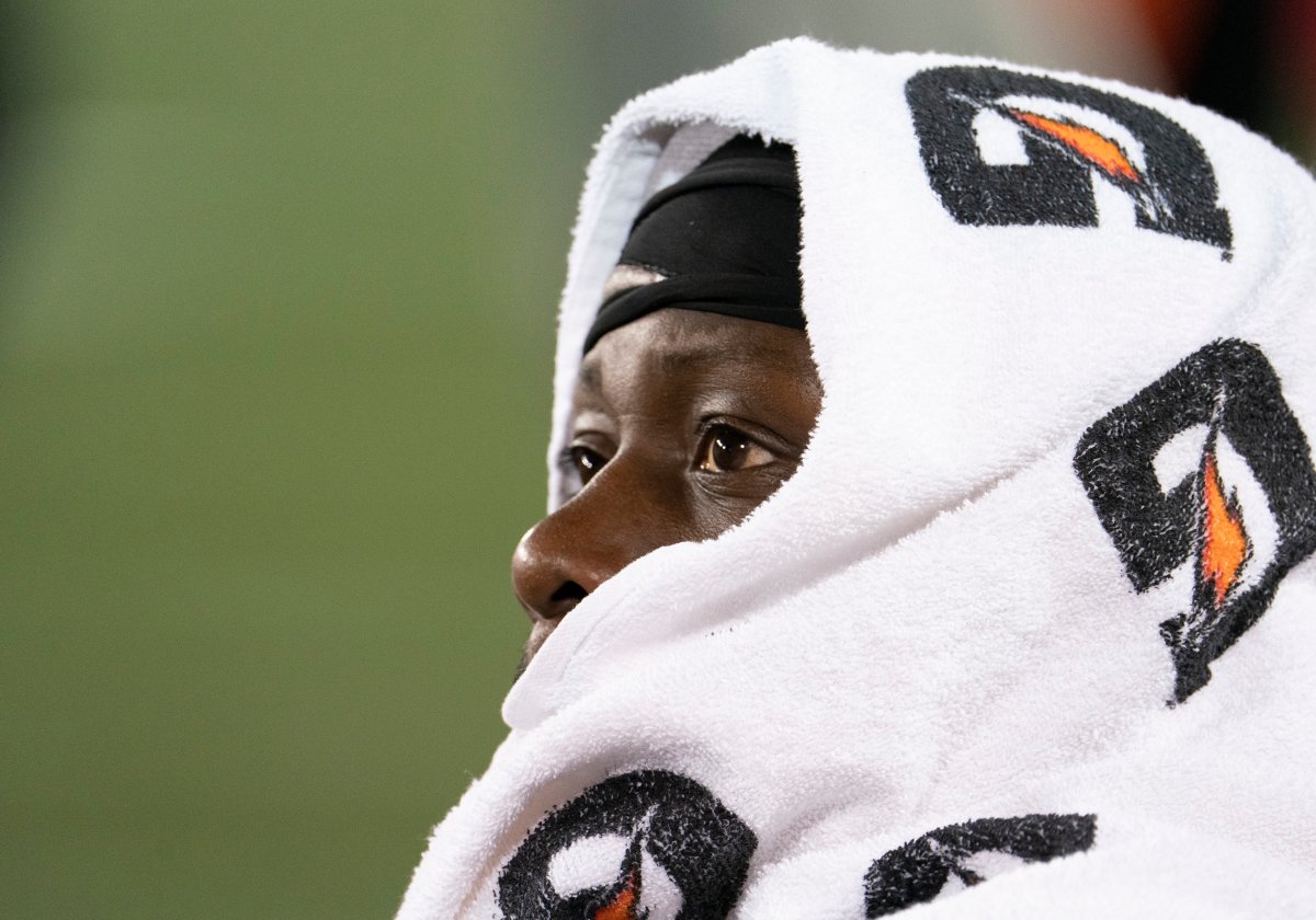 Edmonton Eskimos defensive tackle Almondo Sewell (90) covers his head with a towel while watching from the bench during second half CFL football game action against the Hamilton Tiger Cats, in Hamilton, Ont., Friday, Oct. 4, 2019. 