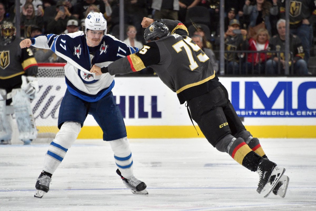 Winnipeg Jets' Adam Lowry (17) fights Vegas Golden Knights right wing Ryan Reaves during the second period of an NHL hockey game Saturday, Nov. 2, 2019, in Las Vegas. 