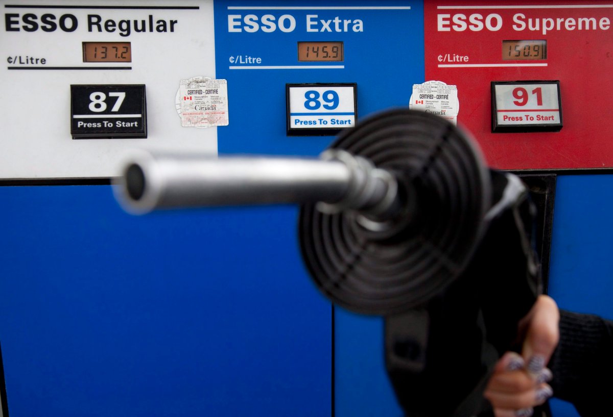 Gas prices are displayed as a motorist prepares to pump gas at a station in North Vancouver on May 10, 2011.