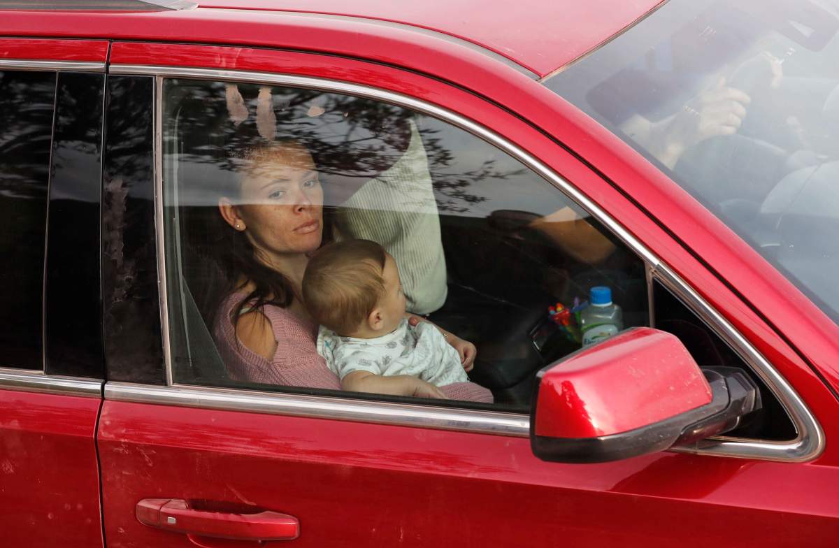Relatives of the LeBaron family arrive at the site where nine U.S. citizens, three women and six children related to the extended LeBaron family, were slaughtered when cartel gunmen ambushed three SUVs along a dirt road near Bavispe, at the Sonora-Chihuahua border, Mexico, Wednesday, Nov 6, 2019. Three women and six of their children, related to the extended LeBaron family, were gunned down in an attack while traveling along Mexico’s Chihuahua and Sonora state border on Monday. (AP Photo/Marco Ugarte)