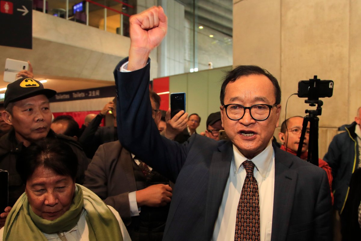 Cambodia's most prominent opposition politician Sam Rainsy clenches his fist as he is attempting to return to Cambodia Thursday, Nov. 7, 2019 at Charles de Gaulle airport, north of Paris.