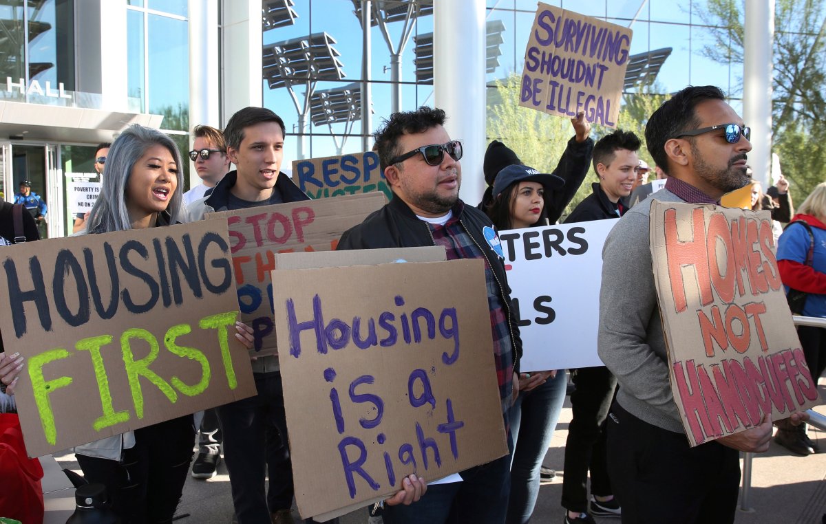 Protesters shout as they hold signs outside Las Vegas City Hall during a protest against the city council's ban on homeless camping on Wednesday, Nov. 6, 2019.