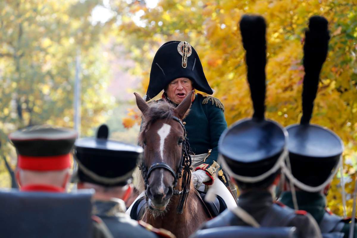 (FILE) – Members of military history clubs wearing 1812-era Russian military-style uniforms march take part in a historical festival to mark the 180th anniversary of the Moscow Triumphal Gates in St. Petersburg, Russia, on Oct. 13, 2018.