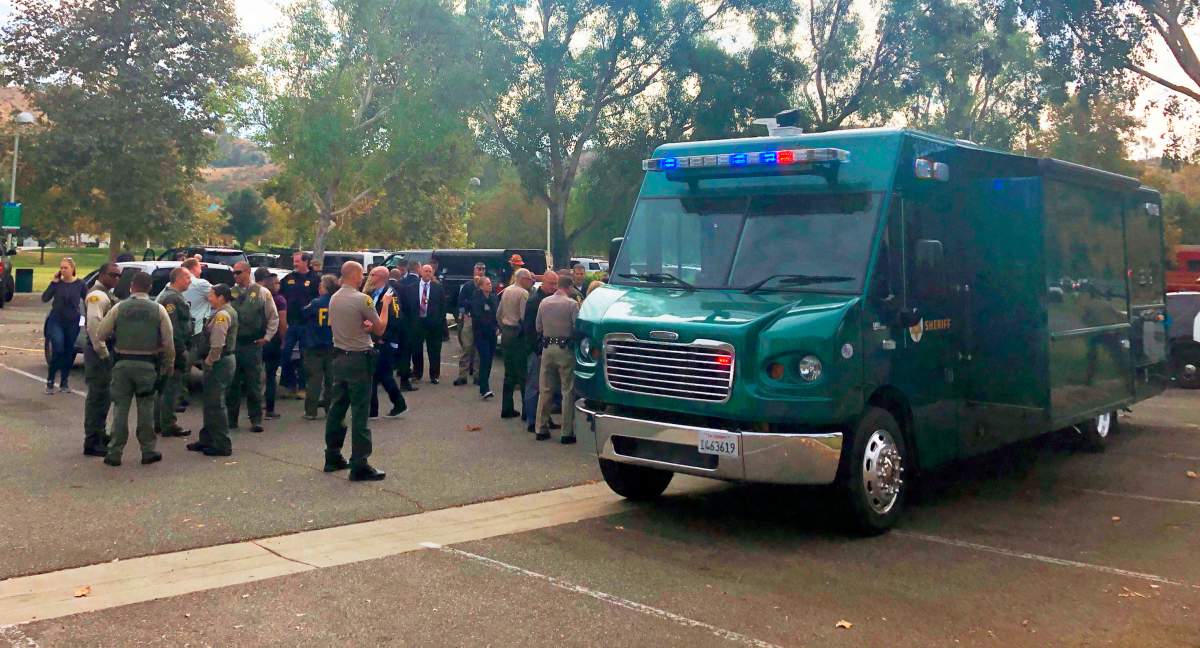 Law enforcement personnel gather outside Saugus High School following a shooting in Santa Clarita, Calif., Thursday, Nov. 14, 2019. (AP Photo/Stefanie Dazio)