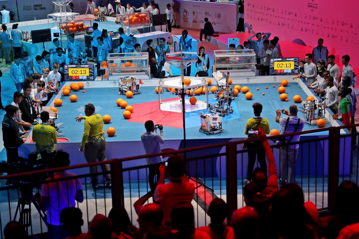 In this Friday, Oct. 25, 2019 photo, a team from Cameroon, on the right, compete with Luxembourg during the First Global Challenge, a robotics and artificial intelligence competition in Dubai, United Arab Emirates. 