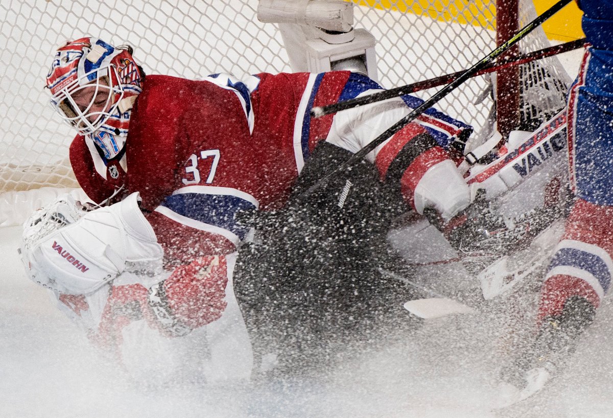 New Jersey Devils' Miles Wood (44) slides in on Montreal Canadiens goaltender Keith Kinkaid during first period NHL hockey action in Montreal, Saturday, November 16, 2019. 