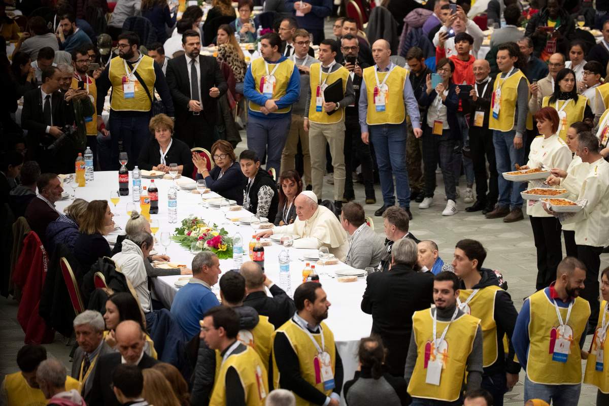 Pope Francis sits at a table during a lunch, in the Paul VI Hall at the Vatican, Sunday, Nov. 17, 2019. Pope Francis is offering several hundred poor people, homeless, migrants, unemployed, a lunch on Sunday as he celebrates the World Day of the Poor with a concrete gesture of charity in the spirit of his namesake, St. Francis of Assisi.