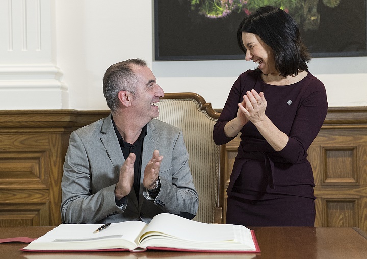 Erick Marciano smiles alongside Montreal Mayor Valérie Plante after signing the Golden Book at City Hall in Montreal, Monday, November 18, 2019. Marciano used his SUV to block a getaway car from potentially plowing into pedestrians at busy intersection in Montreal. 