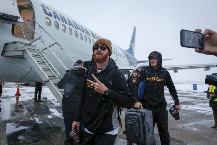 Hamilton Tiger-Cats quarterback Dane Evans, centre, arrives with his team as Grey Cup week gets underway in Calgary, Tuesday, Nov. 19, 2019.