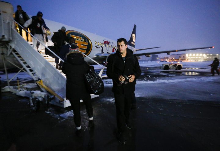 Winnipeg Blue Bombers quarterback Zach Collaros, right, arrives with the rest of his team as Grey Cup week gets underway in Calgary, Tuesday, Nov. 19, 2019.