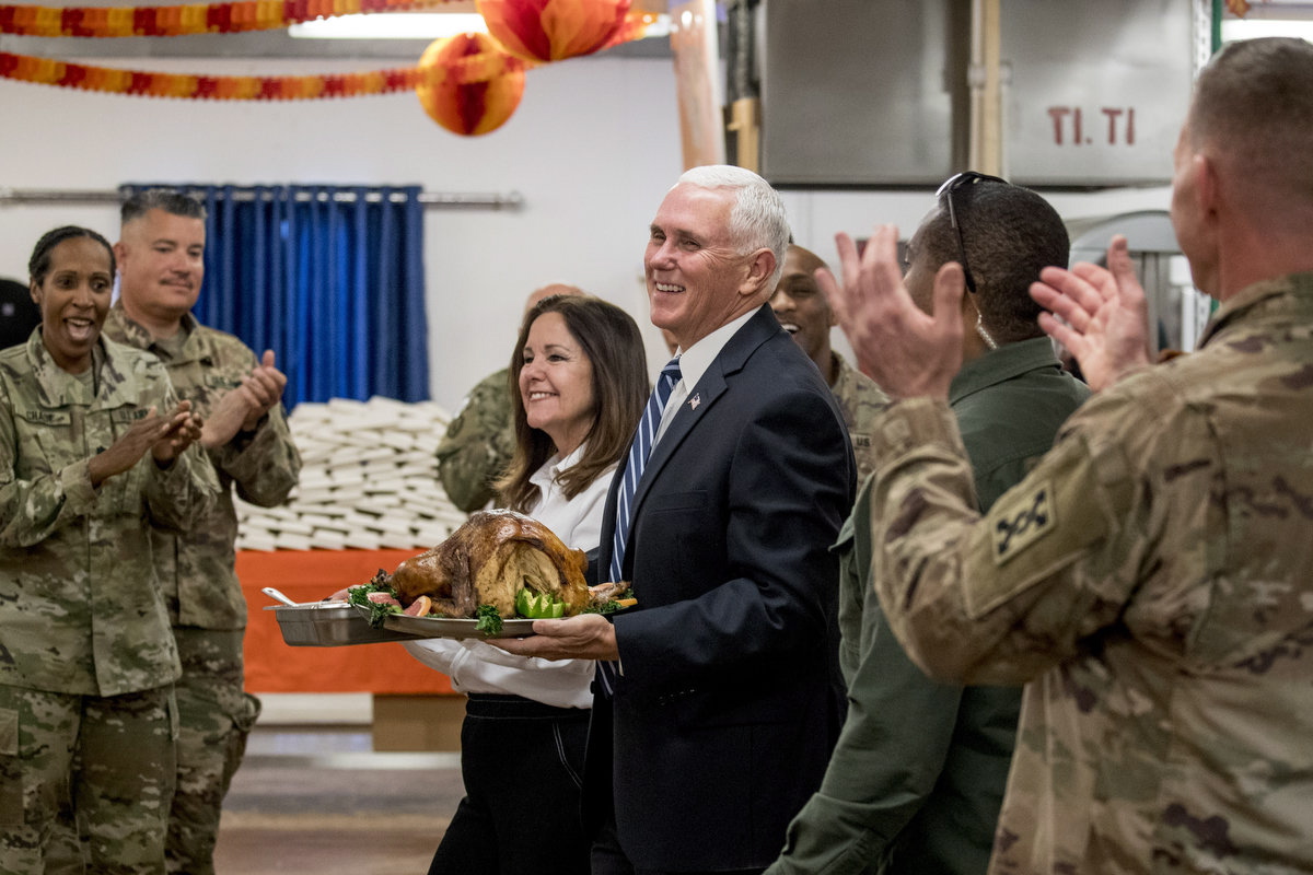 Vice President Mike Pence and his wife Karen Pence arrive with turkey to serve to troops at Al Asad Air Base, Iraq, Saturday, Nov. 23, 2019. (AP Photo/Andrew Harnik)