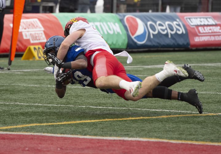 University of Calgary Dinos’ Grant McDonald, top, tackles University of Montreal Carabins’ Ryth-Jean Giraud during first half U Sports Vanier Cup university football action in Quebec City, Sunday, Nov. 23, 2019.