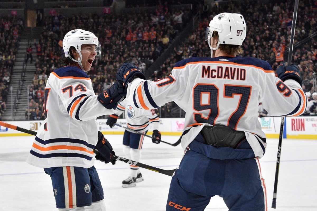 Edmonton Oilers defenseman Ethan Bear (74) and center Connor McDavid celebrate Bear's goal against the Vegas Golden Knights during the first period of an NHL hockey game Saturday, Nov. 23, 2019, in Las Vegas. (AP Photo/David Becker).