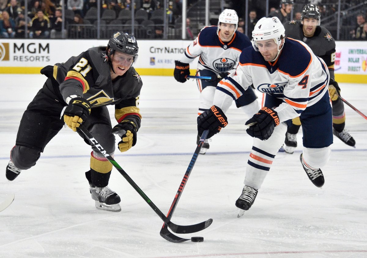 Vegas Golden Knights center Cody Eakin (21) vies for the puck against Edmonton Oilers defenseman Kris Russell during the second period of an NHL hockey game Saturday, Nov. 23, 2019, in Las Vegas. (AP Photo/David Becker).