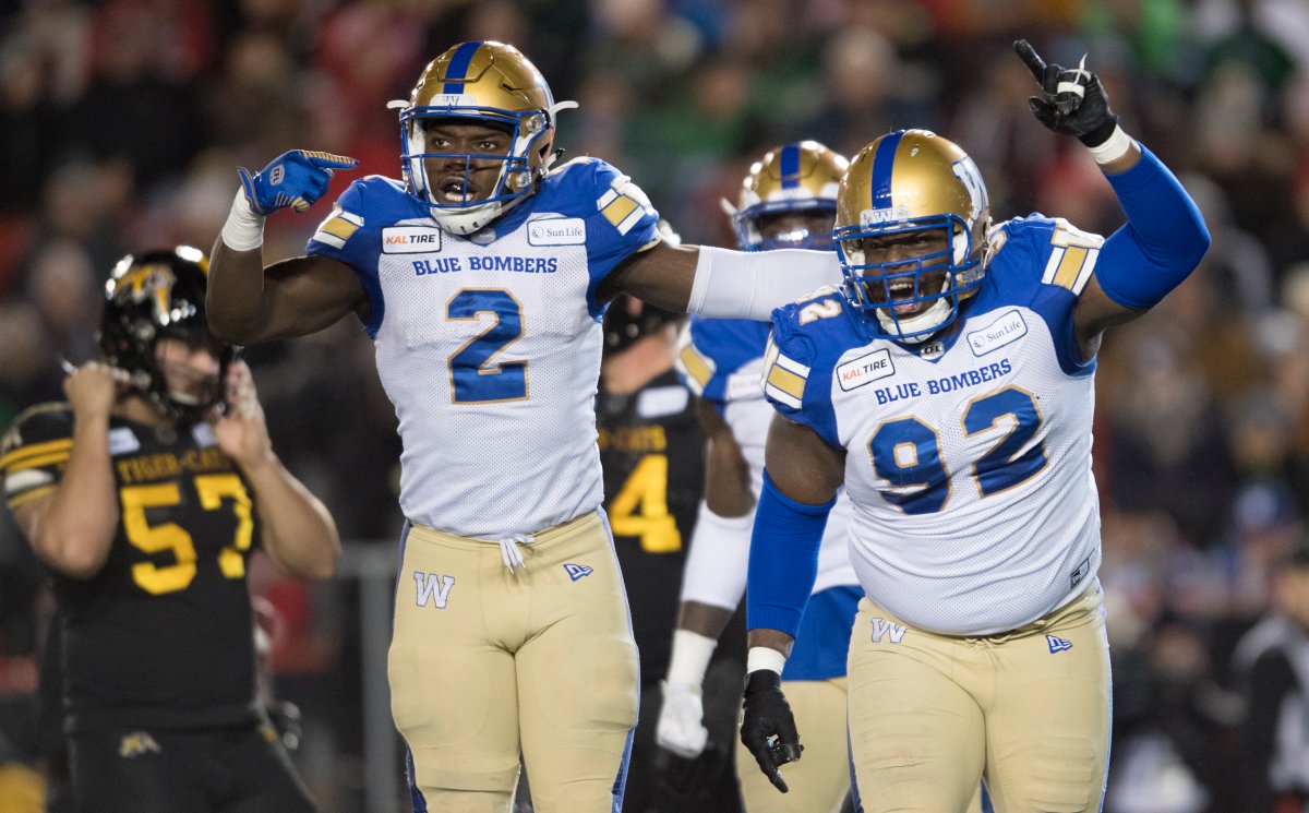Winnipeg Blue Bombers' Drake Nevis, right, celebrates a quarterback sack with Jonathan Kongbo during first half football action in the 107th Grey Cup against the Hamilton Tiger-Cats in Calgary, Alta., Sunday, Nov. 24, 2019.