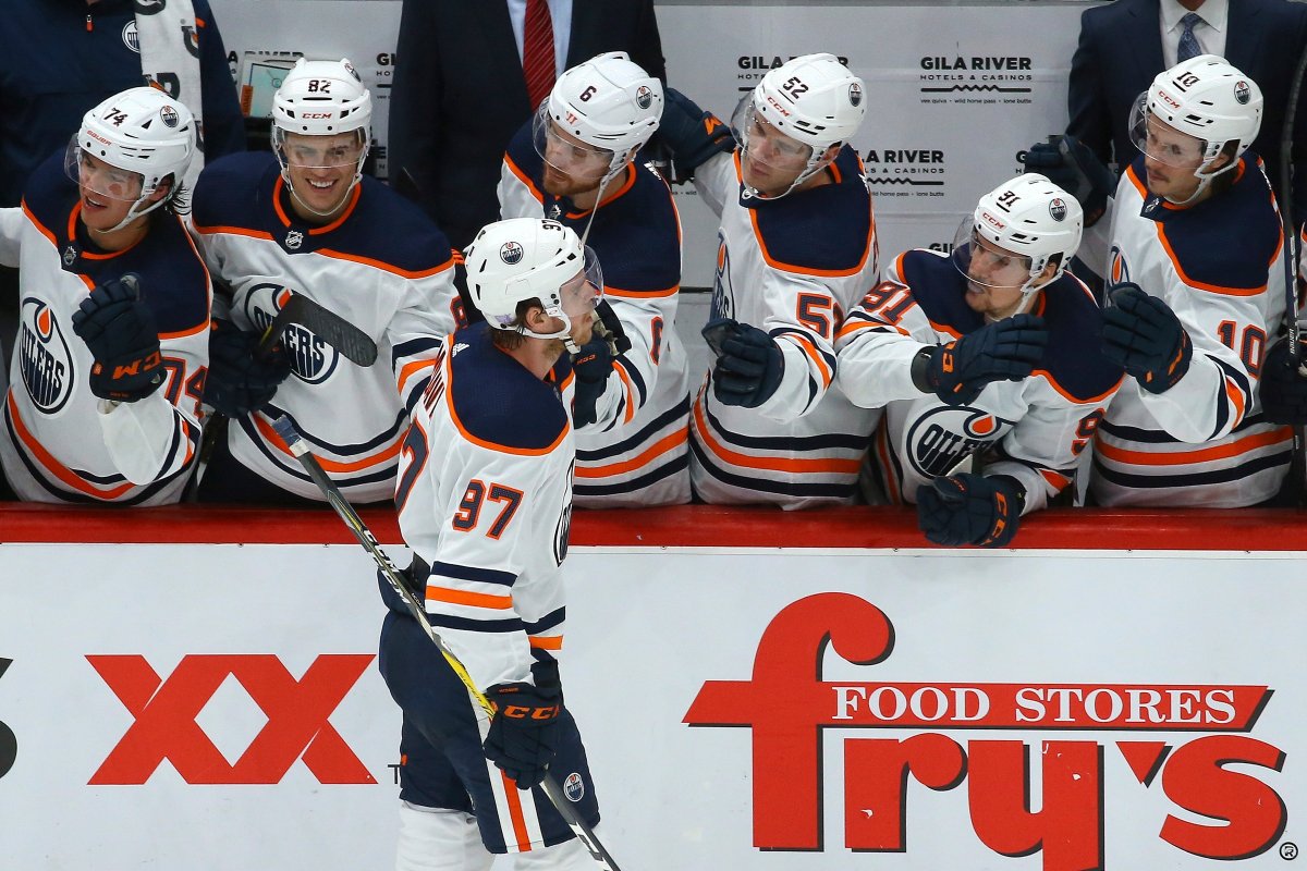Edmonton Oilers center Connor McDavid (97) celebrates his goal against the Arizona Coyotes with Oilers' Ethan Bear (74), Caleb Jones (82), Adam Larsson (6), Patrick Russell (52), Gaetan Haas (91) and Joakim Nygard (10) during the shootout of an NHL hockey game Sunday, Nov. 24, 2019, in Glendale, Ariz. The Oilers defeated the Coyotes 4-3. (AP Photo/Ross D. Franklin).
