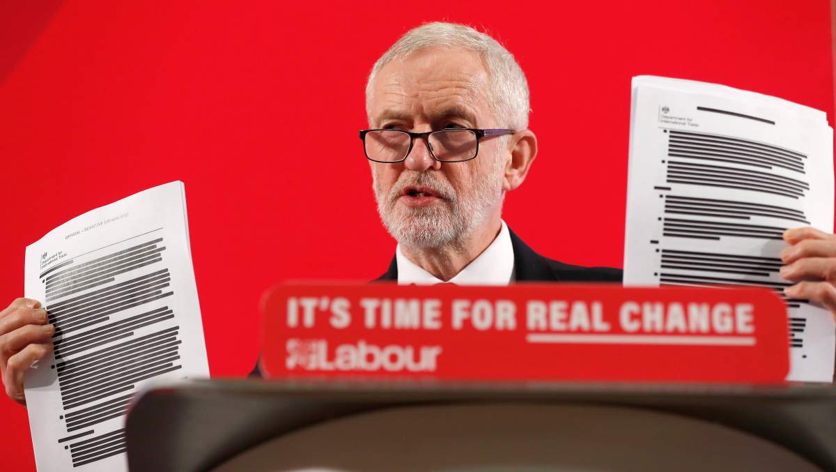 Britain’s Labour party leader Jeremy Corbyn shows blacked out papers as he delivers a speech in London, England, Nov. 27, 2019, ahead of the general election on Dec. 12.