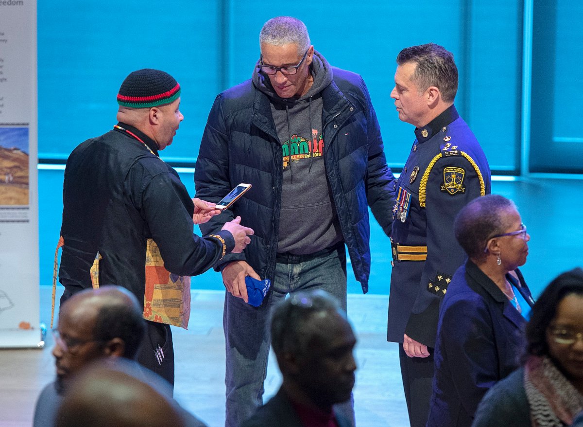 Halifax Regional Police Chief Dan Kinsella, right, chats with community members after he addressed the audience as the force deals with historic complaints of racial profiling in Halifax on Friday, Nov. 29, 2019. Kinsella apologized for years of police street checks that disproportionately targeted black people.