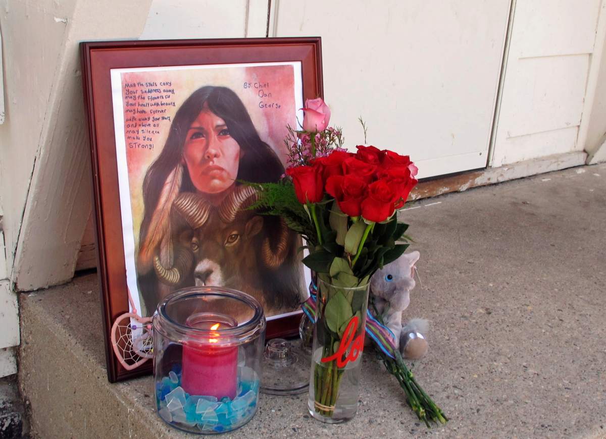 A makeshift memorial to Savanna Greywind featuring a painting, flowers, candle and a stuffed animal is seen on Monday, Aug. 28, 2017, in Fargo, N.D., outside the apartment where Greywind lived with her parents.