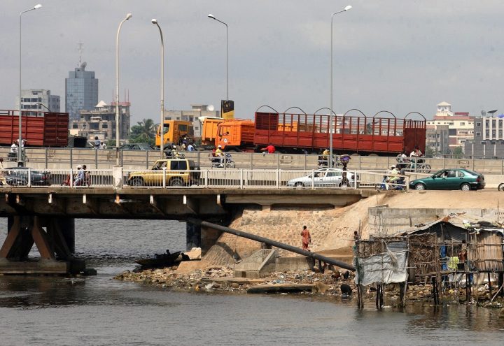 Motorists drive across a bridge towards the business district in Cotonou, Benin Republic, Friday Nov. 23 2007. A vessel owned by Norwegian shipping firm J.J. Ugland was boarded by pirates while at anchor off the coast of Benin on Saturday, and nine crew members were kidnapped. 