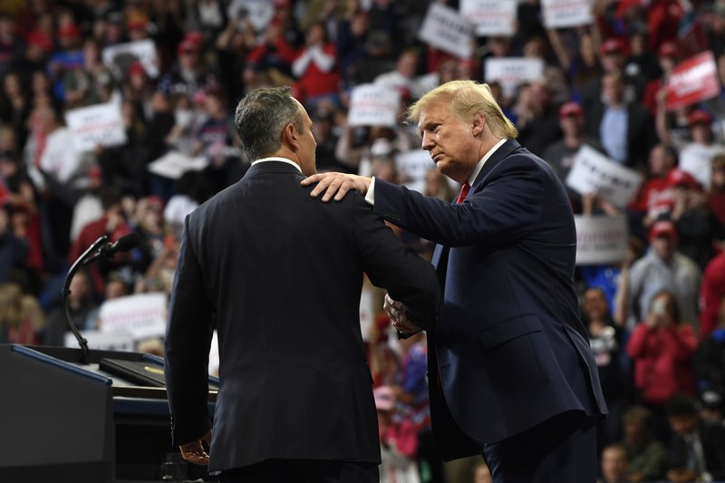 President Donald Trump, left, talks to Kentucky Gov. Matt Bevin, right, during a campaign rally in Lexington, Ky., Monday, Nov. 4, 2019. 