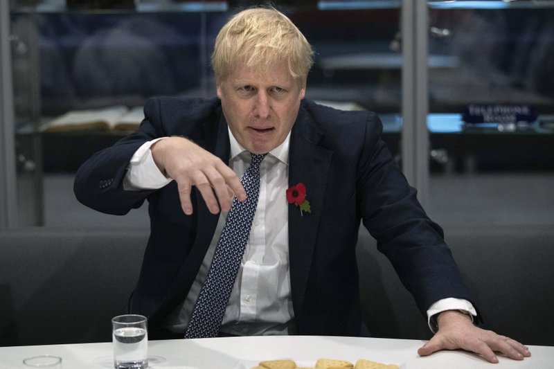 Britain's Prime Minister Boris Johnson gestures, during a visit to Metropolitan Police training college in Hendon, north London, Thursday, Oct. 31, 2019. 