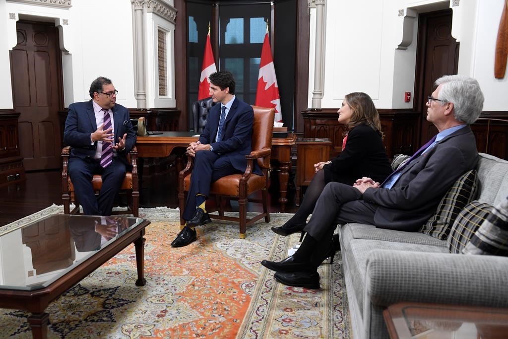 Deputy Prime Minister Chrystia Freeland and Jim Carr, right, look on as Prime Minister Justin Trudeau speaks with Calgary mayor Naheed Nenshi in his office on Parkiament Hill in Ottawa on Nov. 21, 2019.