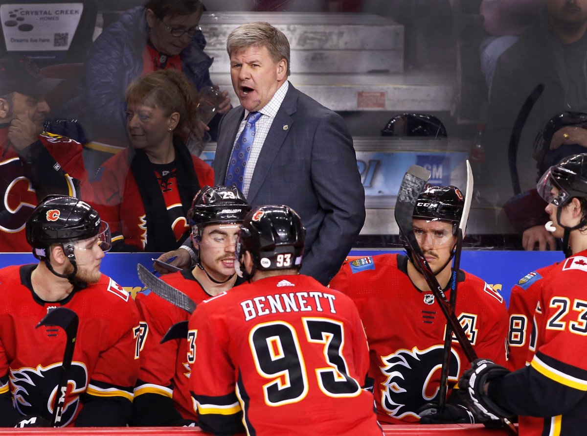 Calgary Flames head coach Bill Peters (centre) during a game against the Dallas Stars in Calgary, AB. on Nov. 28, 2018.