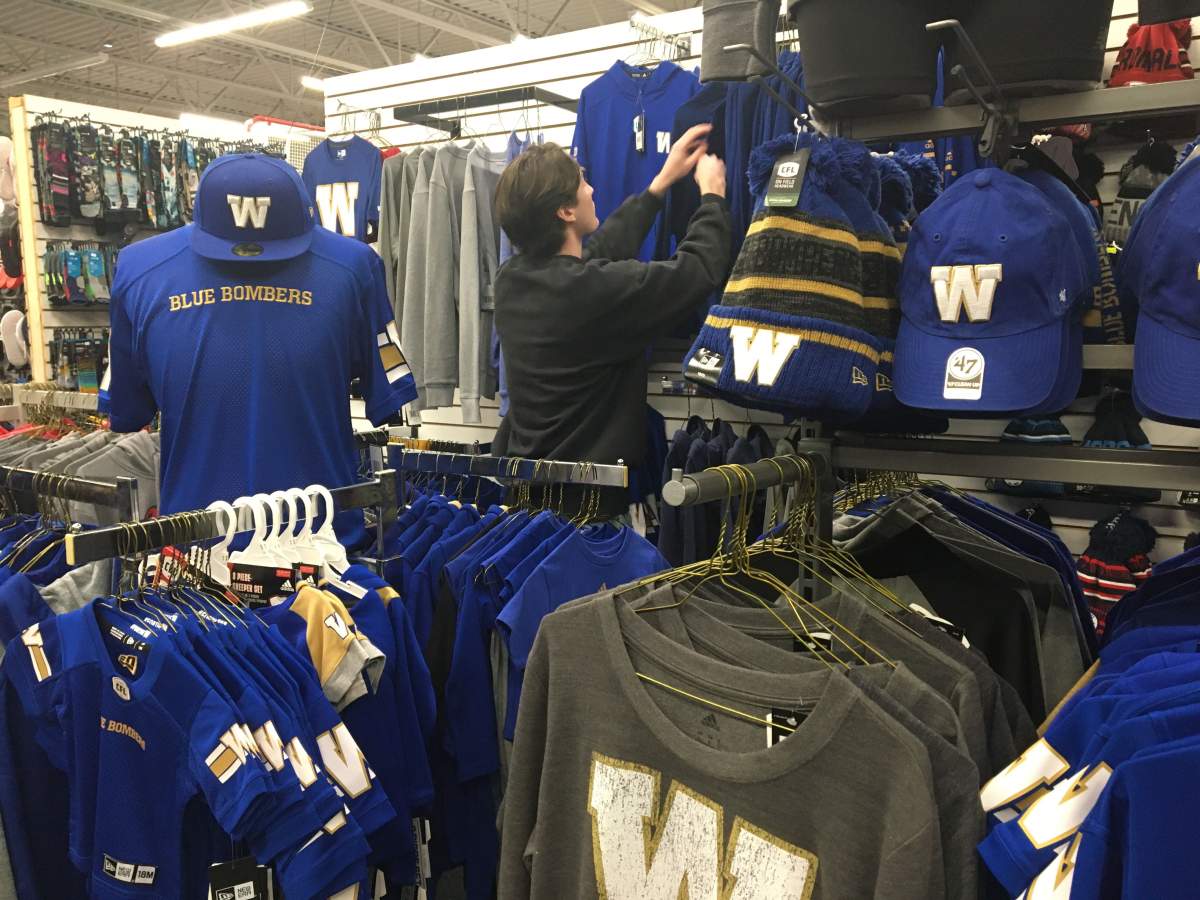 Daniel McCullough fixing up the Blue Bombers display at Royal Sports. 